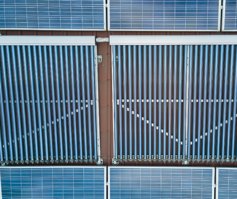 building-roof-with-rows-blue-photovoltaic-panels-vacuum-air-solar-collectors-water-heating-producing-clean-ecological-electricity-renewable-electric-heat-energy-with-zero-emission